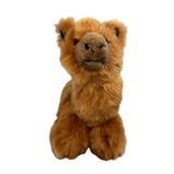 a charming brown plush toy alpaca in a lying position