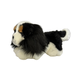 a really cute handmade realistic plush puppy in a lying position