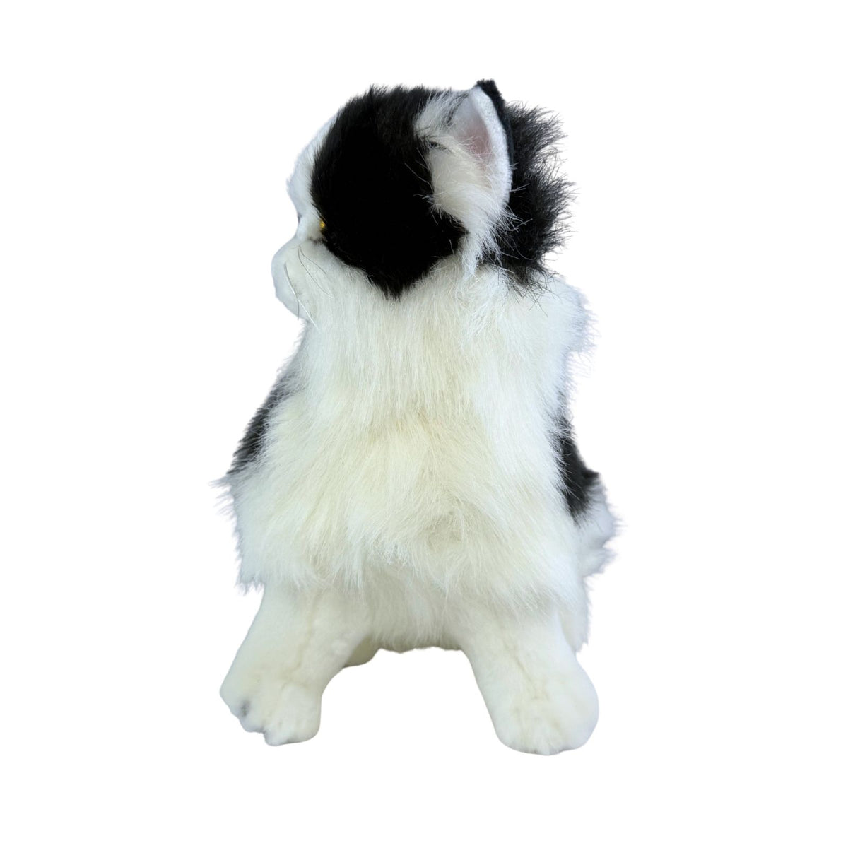 a sitting Piebald cat in white and black colour and is a realistic soft plush toy