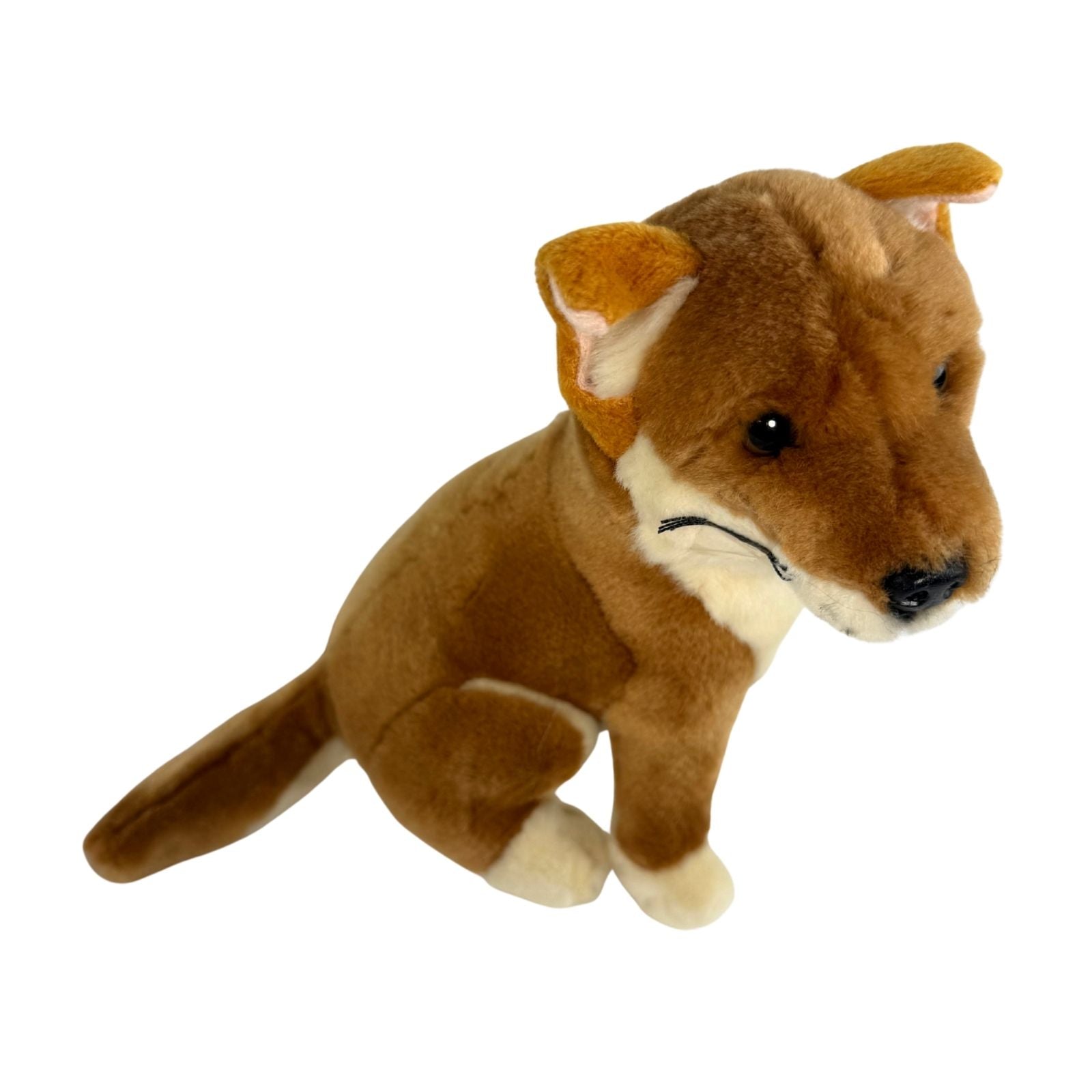 A brown realistic soft plush toy black and tan dingo in a sitting position
