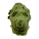 Green plush toy resembling a crocodile head on a white background