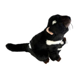 Plush toy resembling a black and white animal on a white background