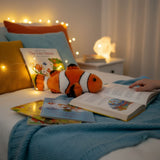 Clown fish plush toy on a bed