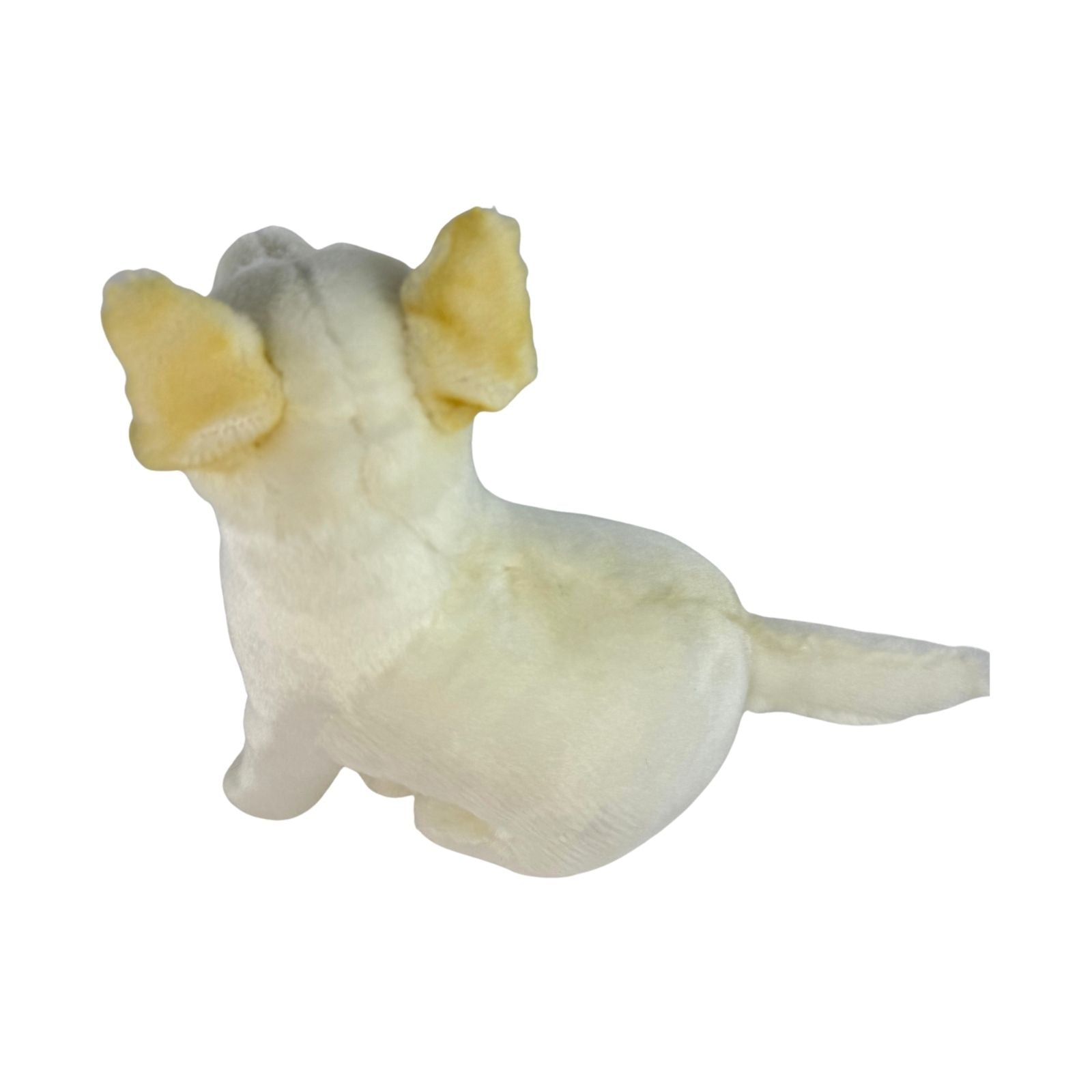 Small white dingo figurine with yellow ears on a white background