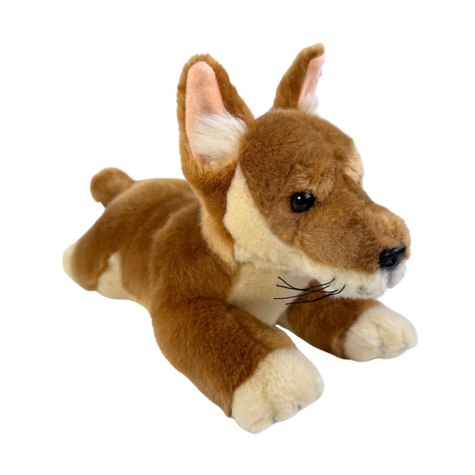 Plush toy dog in a lying position on a white background