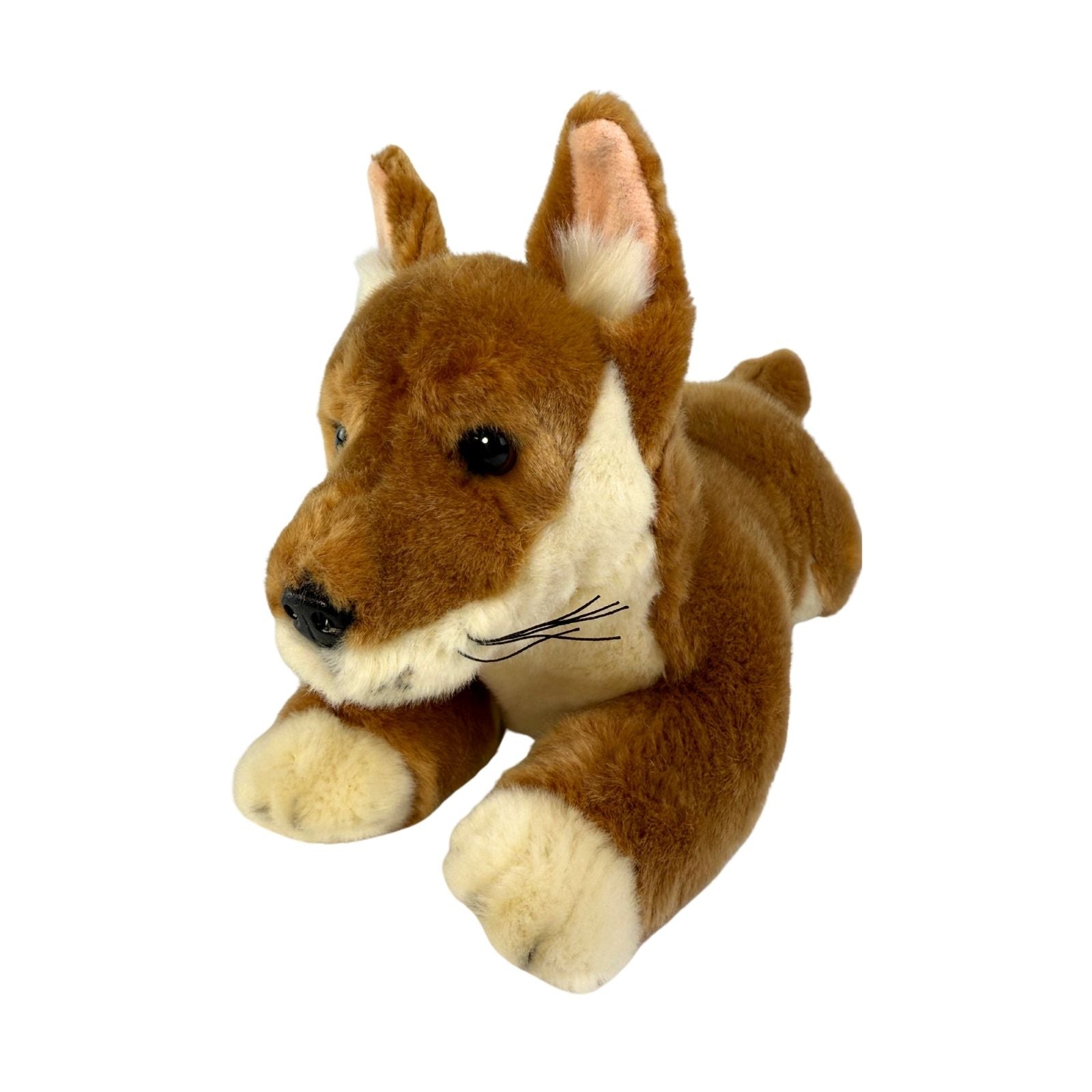 Plush toy dog with brown and white fur on a white background