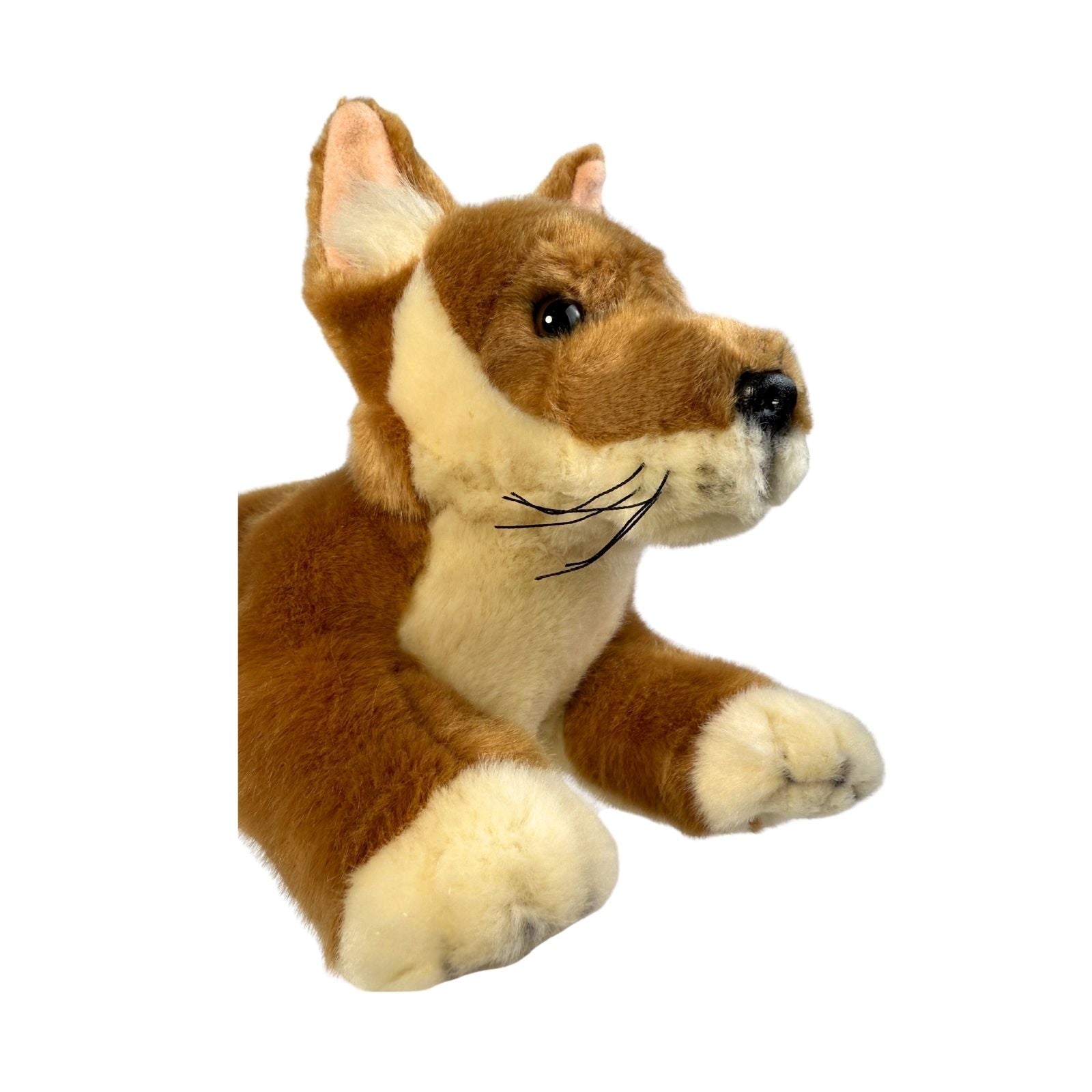 Plush toy dog with brown and beige fur on a white background