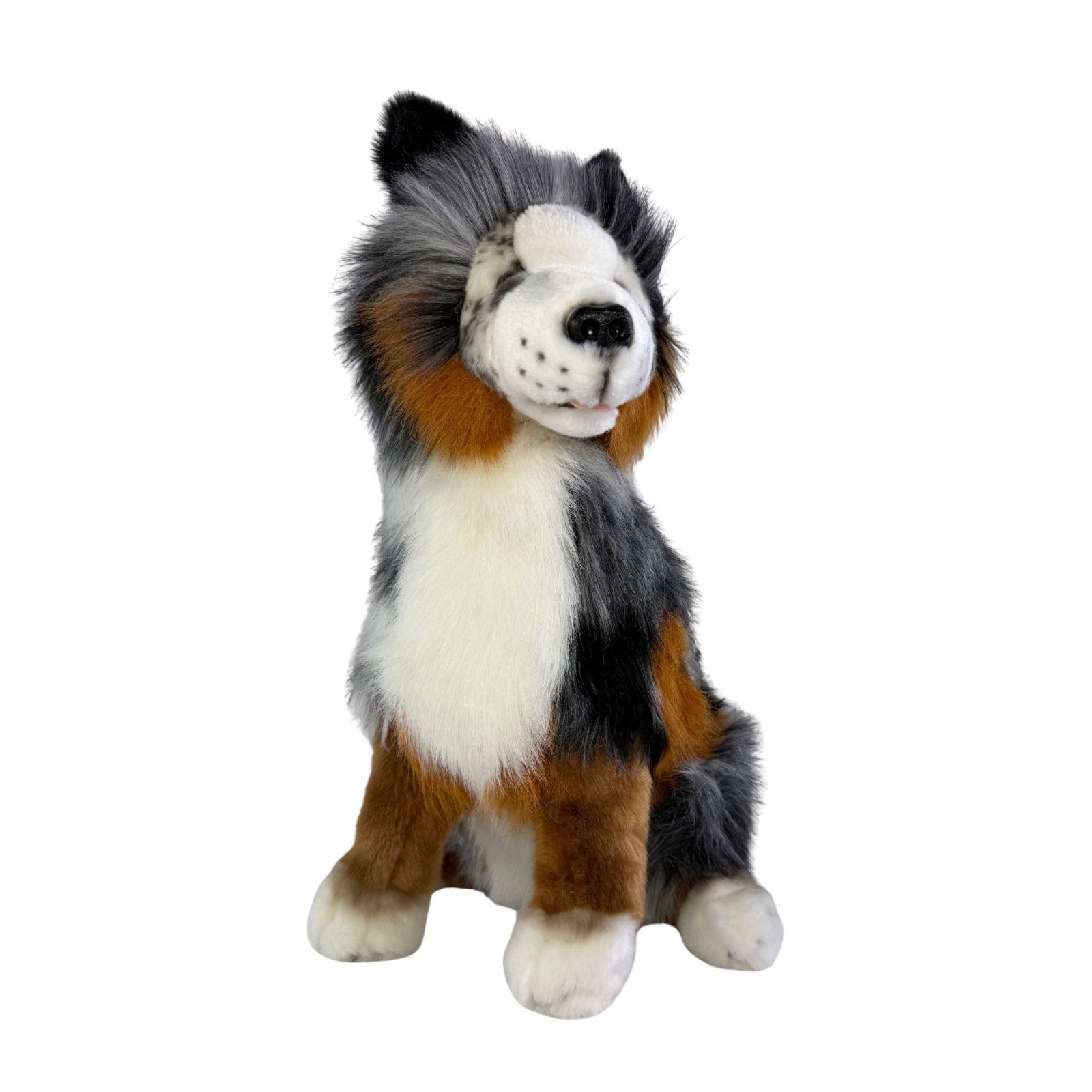 Plush toy dog with black, white, and brown fur on a white background