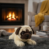 Floppy Pepito pug plush toy on gray rug in cozy living room with fireplace