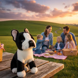 Pierre French Bulldog plush sitting on picnic table with family outdoors