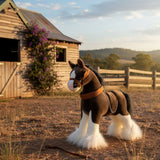Rimsky Clydesdale Horse plush near rustic barn with hills at sunset