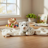 Sheba tiger cub plush toy on knitted blanket in playroom