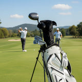 Black Staffy golf club head cover on golf bag with players in the back