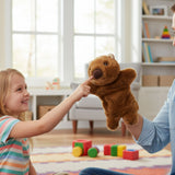 Child touching Womble wombat hand puppet held by adult in bright playroom