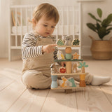 Toddler playing with Aussie animals wooden stacking game on floor