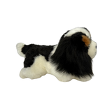 a really cute handmade realistic plush puppy in a lying position