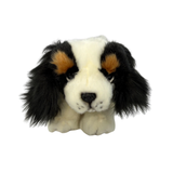 a really cute handmade realistic plush puppy in a lying position