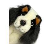 a really cute handmade realistic plush puppy in a lying position