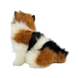 a sitting Calico cat and is a realistic soft plush toy