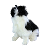 a sitting Piebald cat in white and black colour and is a realistic soft plush toy