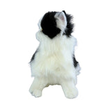 a sitting Piebald cat in white and black colour and is a realistic soft plush toy