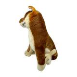 A brown realistic soft plush toy black and tan dingo in a sitting position