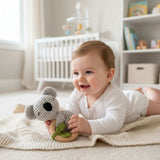 Baby holding knitted koala wooden teether ring