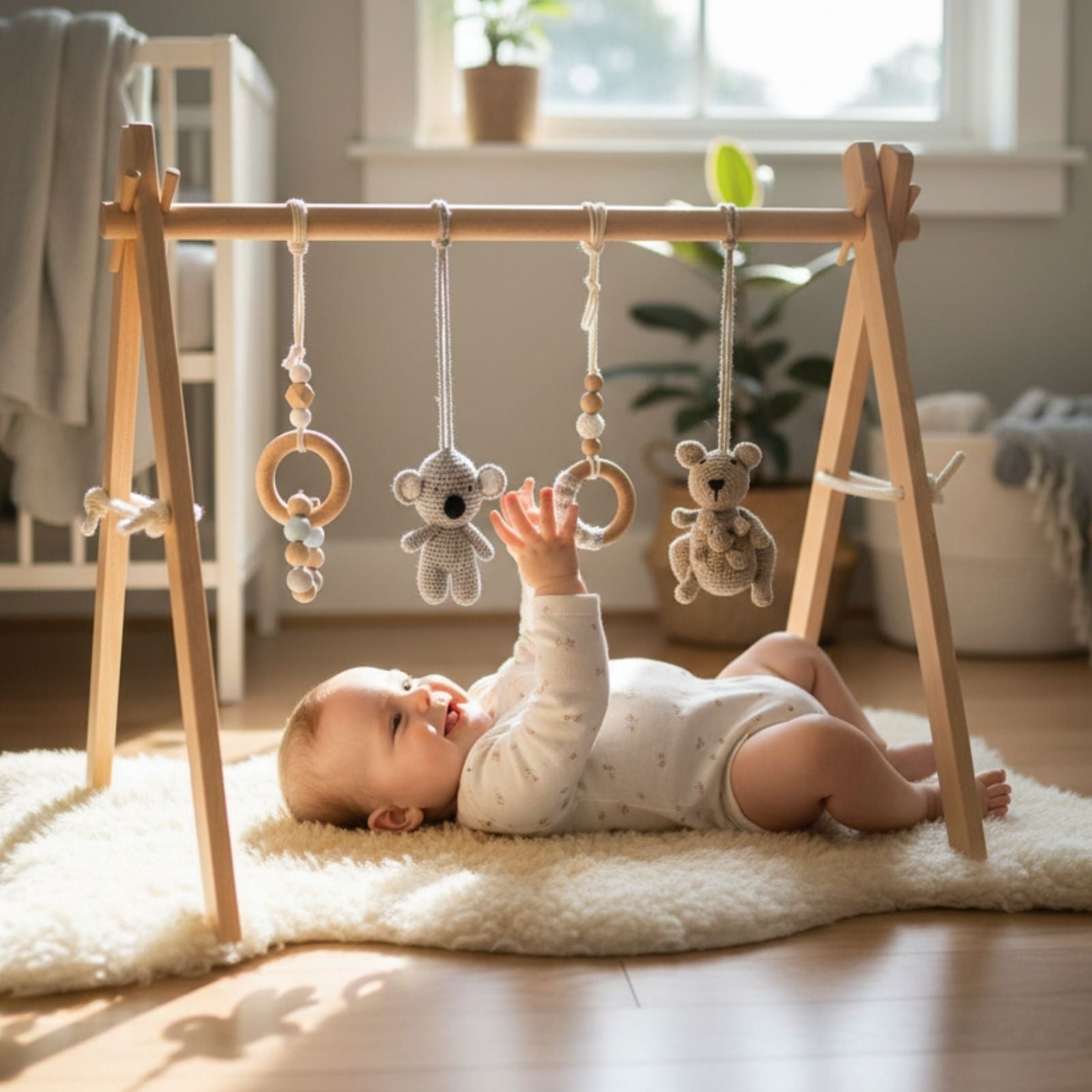 a baby playing Wooden Aussie baby gym with hanging animal toys 