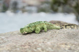The plush toy featured is the Agro Crocodile, a realistic, handcrafted stuffed animal known for its lifelike details.