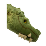 Close-up of a green plush alligator toy on a white background