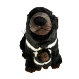 Plush toy otter wearing a striped scarf on a white background