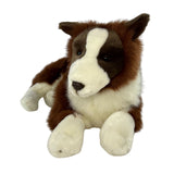 Front view of lying chocolate Border Collie plush toy