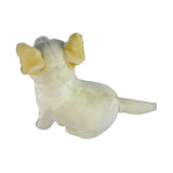 Small white dingo figurine with yellow ears on a white background