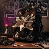 Mini squirrel glider plush keychain on a backpack.