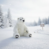 Minka polar bear plush toy sitting on snowy winter landscape.