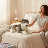 Rocket Husky plush lying on bed