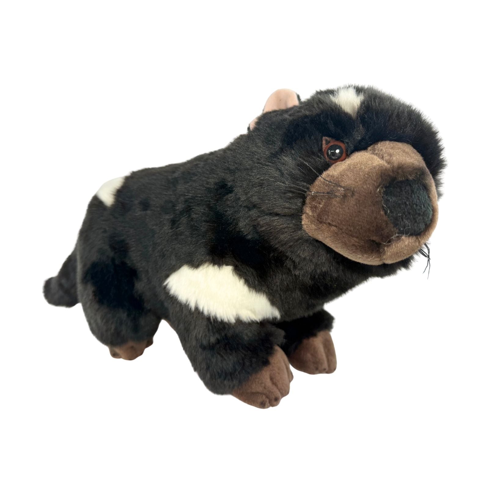 Plush toy resembling a black and brown animal on a white background