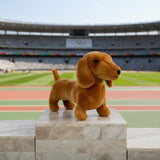 Sadie Dachshund plush standing on marble podium in Olympic stadium