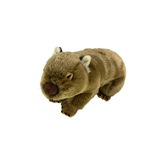 A plush toy resembling a sleeping wombat with brown acrylic fur, white inner ears, and a pink nose.